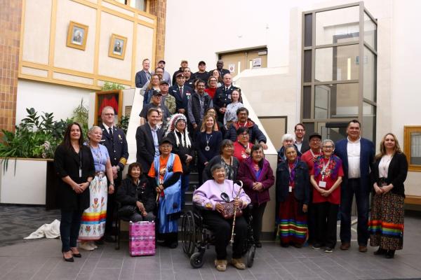 Members of the Peter Ballantyne Cree Nation pose with representatives from the City of Saskatoon in City Hall in May 2025.